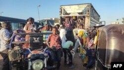 FILE - People displaced by the conflict in Sudan flee Wad Madani, the capital of al-Jazirah state, heading to Gadaref state on December 16, 2023.