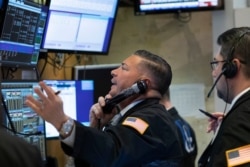 Traders work at the New York Stock Exchange as the market closes, March 18, 2020 in New York. Major U.S. stock indexes closed sharply lower on Wall Street as fears of a prolonged coronavirus-induced recession took hold.