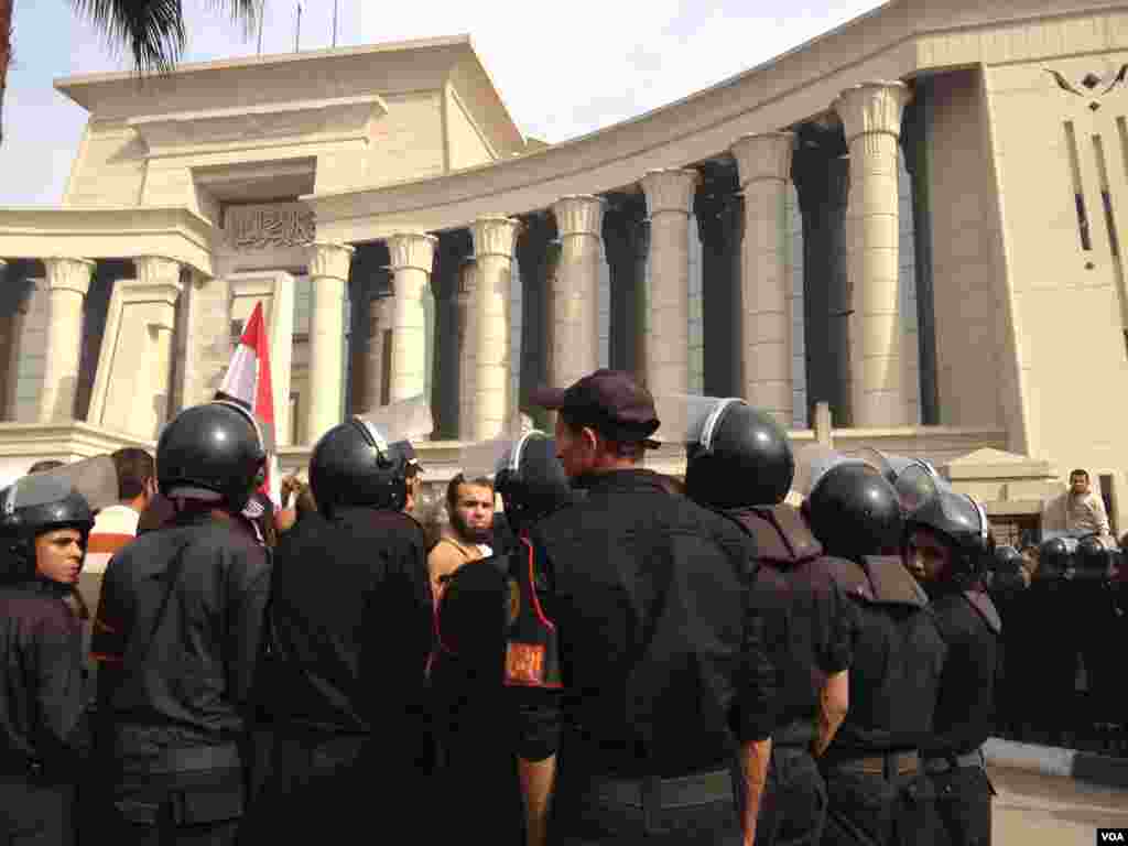 Supporters of Egyptian President Mohamed Morsi keep up a vigil outside the Constitutional Court, as riot police try to keep the building open, Cairo, Egypt, December 3, 2012. (E Arrott/VOA)