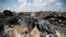 Ukraine -- People walk near the wreckage of Malaysia Airlines MH17, that was shot down near Hrabove, in the Donetsk region, on July 23, 2014.