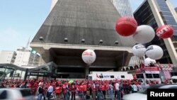 People from various social movements and union workers attend a demonstration in support of human rights and democracy at Paulista avenue in Sao Paulo's financial center, Brazil, Sept. 15, 2015.