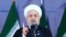 Iran's President Hassan Rouhani speaks at a military parade marking the 38th anniversary of Iraq's 1980 invasion of Iran, in front of the shrine of the late revolutionary founder, Ayatollah Khomeini, outside Tehran, Iran, Saturday, Sept. 22, 2018. 
