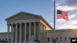 An American flag flies at half-staff at the Supreme Court on the morning after the death of Justice Ruth Bader Ginsburg, in Washington, Sept. 19, 2020.