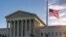 An American flag flies at half-staff at the Supreme Court on the morning after the death of Justice Ruth Bader Ginsburg, in Washington, Sept. 19, 2020.