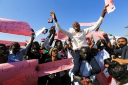 FILE - Supporters of Sudan's President Omar al-Bashir chant slogans to his favor during a rally at Green Square in Khartoum, Sudan, Jan. 9, 2019.