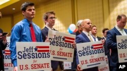 Jeff Sessions supporters hold campaign signs as they listen to his speech at his watch party following Alabama's state primary, March 3, 2020, in Mobile, Ala.