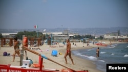 People enjoy their holidays at the beach in Catania, on the island of Sicily, Italy, Aug. 9, 2019.