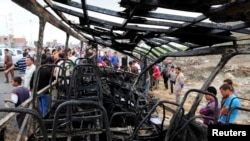 Relatives of students and members of the public look at the wreckage of a school bus after it crashed in Damanhur November 5, 2014. 