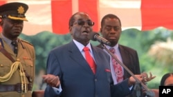 FILE Zimbabwean President Robert Mugabe addresses supporters at the party headquarters in Harare, Wednesday Feb, 10, 2016. 