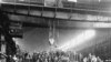 One hundred factory workers pose for a photo, probably between 1910 and 1920, in front of a 100-ton crane they constructed at the Illinois Steel Company's South Works Machine Shop. This photograph, which appears in the book "Chicago's Southeast Side," is 