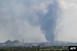 A plume of smoke rises in the area of the town of Toretsk, in the Donetsk region, on Aug. 24, 2025, amid the Russian invasion of Ukraine.