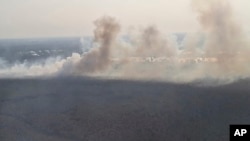 This photo released by Banjarmasin Disaster Management Agency, shows a fire that razes through a land in Banjarmasin, South Kalimantan, Indonesia, Friday, Oct. 6, 2023. (Banjarmasin Disaster Management Agency via AP)