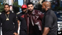 Drake, center, arrives at the premiere for "The Carter Effect" on day 3 of the Toronto International Film Festival at the Princess of Wales Theatre on Sept. 9, 2017, in Toronto. 