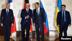 From right, Foreign Ministers Pavlo Klimkin of Ukraine, Sergei Lavrov of Russia, Frank-Walter Steinmeier of Germany and Jean-Marc Ayrault of France pose for a picture as they gather for talks on the crisis in eastern Ukraine, in Minsk, Belarus, Nov. 29, 2016.