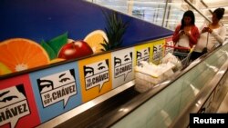 Women leave state-run supermarket 'Bicentenario' after shopping in Caracas June 4, 2013