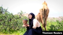 FILE - Caption Somali-Canadian journalist Hodan Nalayeh smiles in Laascaanood, Somalia, June 15, 2019.