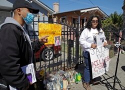 By Any Means Necessary National Organizers Hoku Jeffrey, left, gestures beside Maricruz Lopez during a media conference, June 8, 2020, at the side where Eric Salgado was killed by Oakland police on June 2, 2020, in Oakland, Calif.