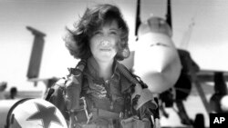 In this image provided by the U.S. Navy, Lt. Tammie Jo Shults, one of the first women to fly Navy tactical aircraft, poses in front of an F/A-18A with Tactical Electronics Warfare Squadron (VAQ) 34 in 1992. Shults was the pilot of the Southwest plane that made an emergency landing on April 17, 2018, after an engine explosion. (Thomas P. Milne/U.S. Navy via AP)