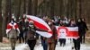Opposition supporters carry historical white-red-white flags of Belarus as they attend a rally to reject the presidential election results in Minsk, Belarus, Dec. 13, 2020. 