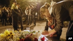 Girls light candles in memory of victims of a Russian plane crash, in downtown Yaroslavl, September 7, 2011.