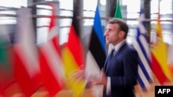 France's President Emmanuel Macron speaks to the press as he arrives prior to an EU summit in Brussels, on October 15, 2020.