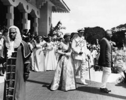 FILE - In this April 12, 1954, photo, Britain's Queen Elizabeth II and her husband the Duke of Edinburgh leave Freedom Hall in Colombo, Sri Lanka, after opening parliament.