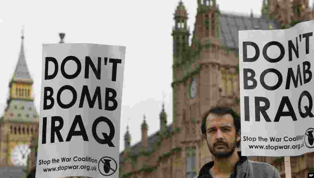 A demonstrator holds an antiwar banner near Parliament in London, Sept. 26, 2014.