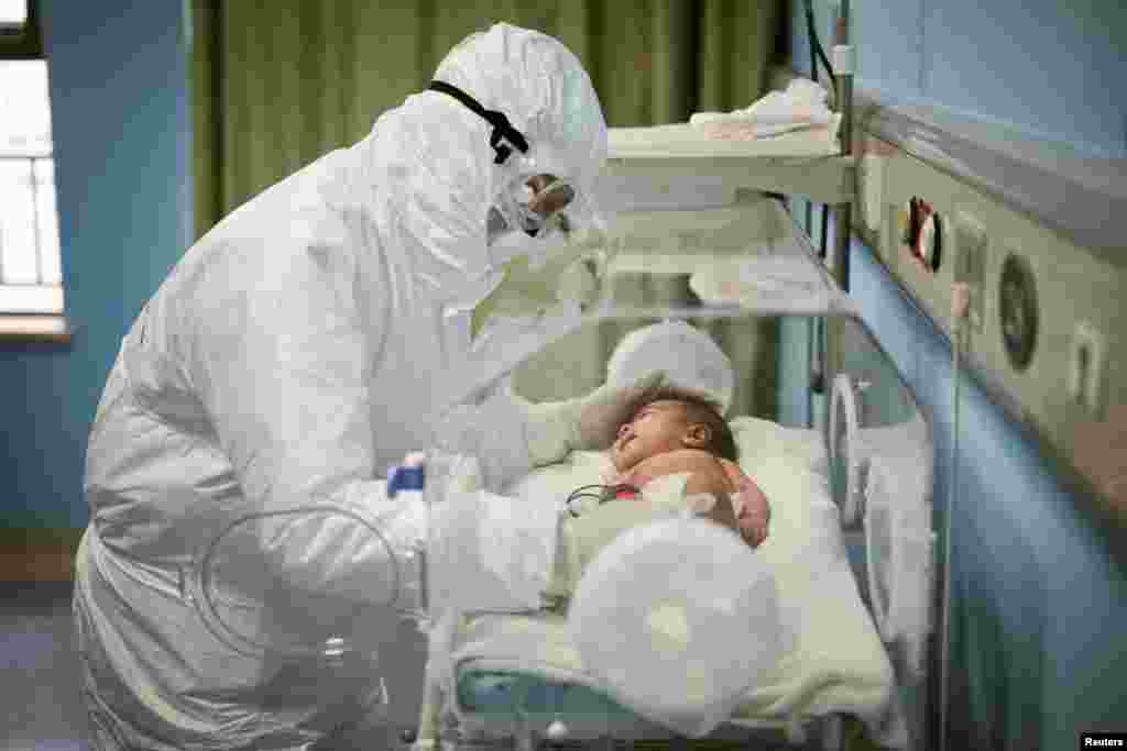 A medical staffer attends to a baby with the coronavirus at the Wuhan Children’s Hospital, in Wuhan, the epicenter of the outbreak, in Hubei province, China.