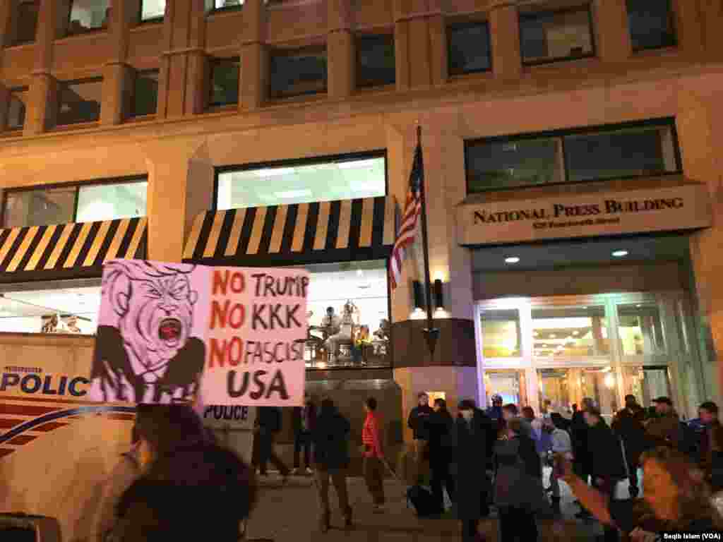 Protesters outside the National Press Club in Washington, D.C., hold signs saying No Trump, No KKK, No Fascist USA on the eve of the inauguration of President-elect Donald Trump, Jan. 19, 2017.