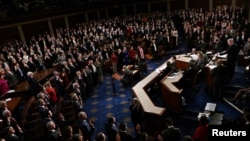 FILE - Members of the 118th Congress raise their right hands as they are sworn into office to serve in the U.S. House of Representatives on the fourth day of Congress at the U.S. Capitol in Washington, Jan. 7, 2023.