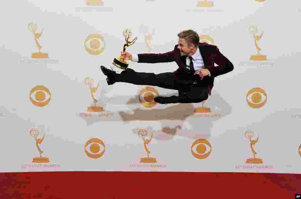 Derek Hough poses backstage with the award for outstanding choreography for his work on &#39;Dancing with the Stars&#39; at the 65th Primetime Emmy Awards at the Nokia Theatre in Los Angeles, Sept. 22, 2013.