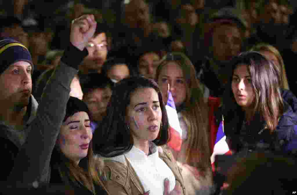 People gather and sing the French national anthem at a vigil in a tribute to the victims of the Bastille Day attack, in Sydney, Australia, July 15, 2016.