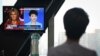 China's state broadcaster CGTN anchor Liu Xin looks at a screen showing her debate with Fox Business Network presenter Trish Regan, at the CCTV headquarters in Beijing on May 30, 2019.