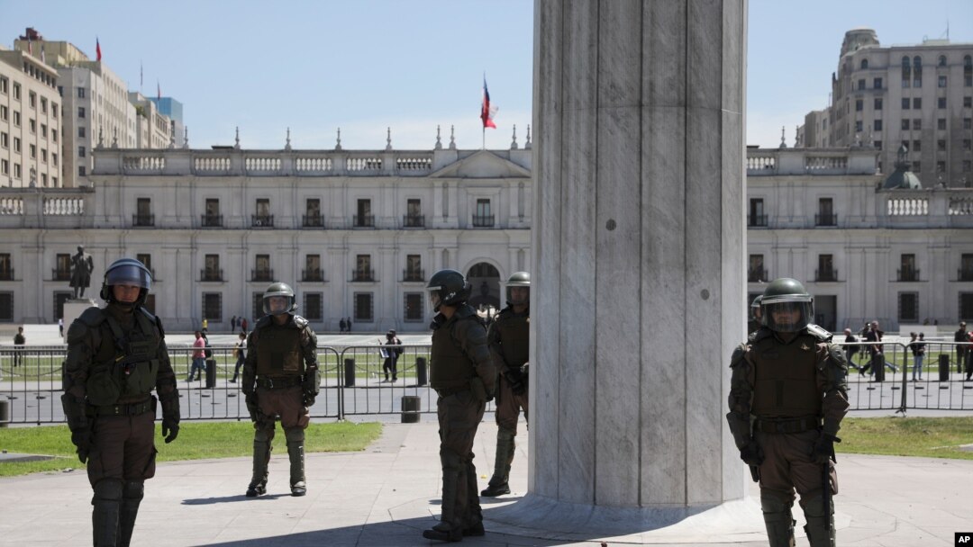 Riot police guard La Moneda presidential palace in Santiago, Chile, Oct. 30, 2019. 