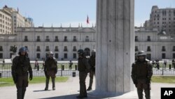 Riot police guard La Moneda presidential palace in Santiago, Chile, Oct. 30, 2019. 