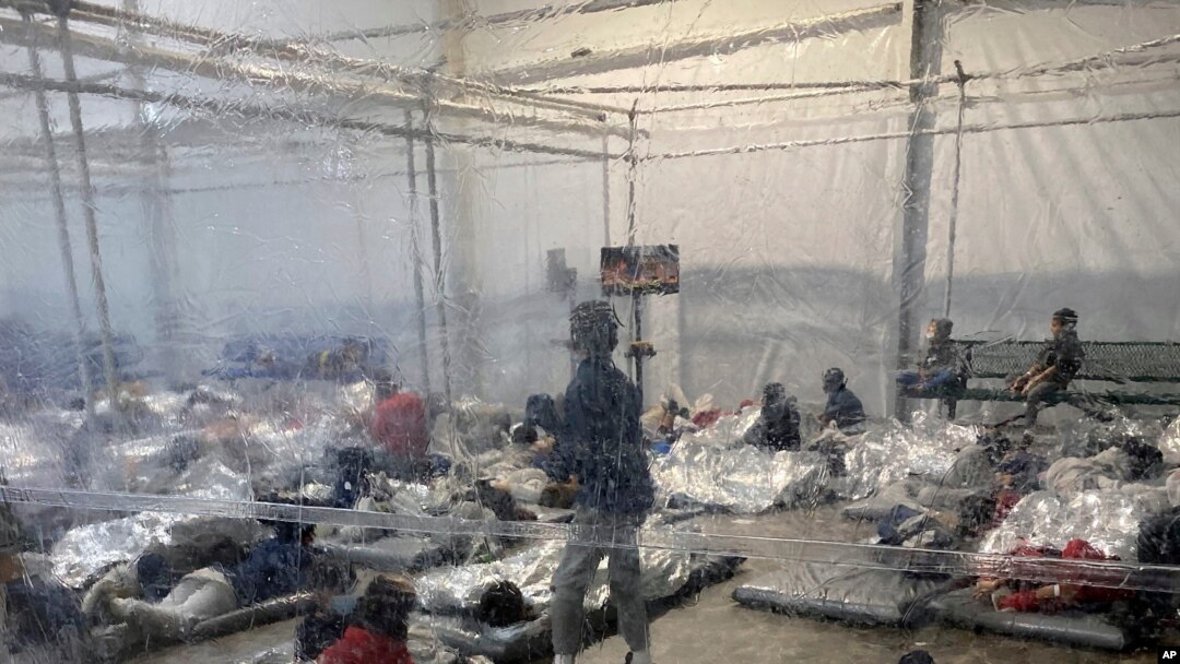 File - This March 20, 2021, photo provided by the Office of Rep. Henry Cuellar, D-Texas, shows detainees in a Customs and Border Protection (CBP) temporary overflow facility in Donna, Texas.