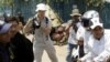 A Cambodian protester from Boueng Kak lake is carried by police officers while demonstrating near the area where she owned a home, in Phnom Penh. At least two women were arrested by local authorities while demanding compensation for being evicted from the