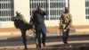 FILE: A soldier assaults a man on the streets of Harare following demonstrations by opposition party supporters.