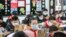 Elementary school students wearing face masks attend a class as they return to school after the start of the term was delayed due to the COVID-19 coronavirus outbreak, in Huaian in China's eastern Jiangsu province, Apr. 7, 2020.