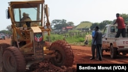 A worker uses heavy machinery as he works on the busy road connecting Kuacjok to Tharkueng in September 2014. Locals welcomed the repairs, which they say are vital to their and other road users' well being. 