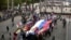 About a hundred people with flags of the self-proclaimed Donetsk People's Republic, as well as Sevastopol and Russian Imperial flags and big Russian flag gather in a rally in Moscow's Gorky Park on May Day, May 1, 2014.