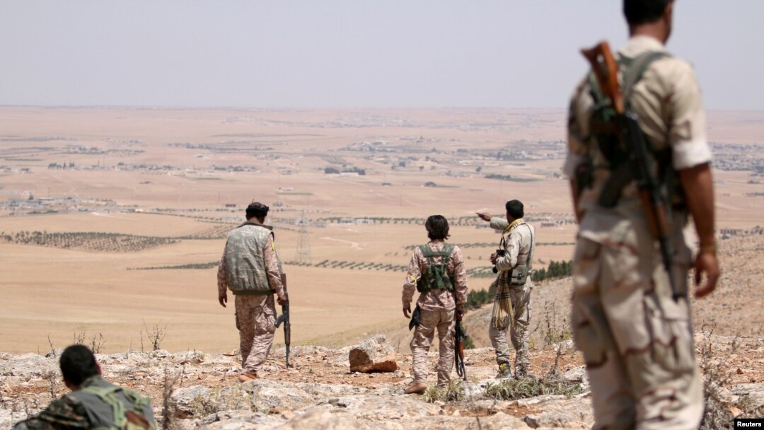 Fighters of the Manbij military council, take an overwatch position in the southern rural area of Manbij, Syria, June 1, 2016. 