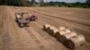 (FILE) A tractor collects straw on a field in a private farm in Zhurivka, Kyiv region, Ukraine.