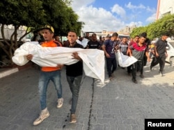 Gazans mourn Palestinians killed in an Israeli strike in Khan Younis, in the southern Gaza Strip, June 30, 2024.