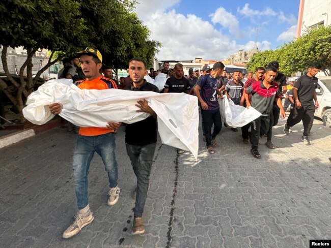 Gazans mourn Palestinians killed in an Israeli strike in Khan Younis, in the southern Gaza Strip, June 30, 2024.