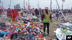 A volunteer helps people to look for their valuables after a stampede when Hindu devotees rushed to take a holy bath during the Maha Kumbh festival in Prayagraj, India, Jan. 29, 2025.