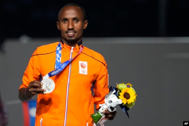 FILE - Silver medalist in the men's marathon Abdi Nageeye, of the Netherlands, poses during the closing ceremony in the Olympic Stadium at the 2020 Summer Olympics, Sunday, Aug. 8, 2021, in Tokyo, Japan. (AP Photo/David Goldman)