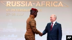 FILE - Burkina Faso's Capt. Ibrahim Traore, left, and Russian President Vladimir Putin shake hands before an official ceremony to welcome the leaders of delegations to the Russia Africa Summit in St. Petersburg, Russia, Thursday, July 27, 2023.
