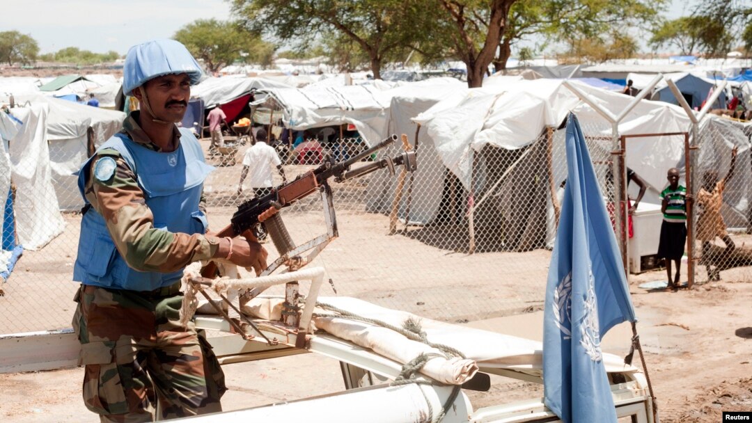 A U.N. peacekeeper keeps guard outside a refugee camp in Bor, South Sudan, on April 29, 2014.