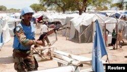 A U.N. peacekeeper keeps guard outside a refugee camp in Bor, South Sudan, on April 29, 2014.